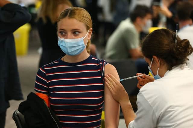 A woman receives a vaccine at the Chelsea F.C. pop up vaccine hub (Photo: Hollie Adams/Getty Images)