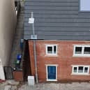 A builder in Ashton-under-Lyne built a house around a lamppost rather than wait for it to be moved. It will be moved at a later date 