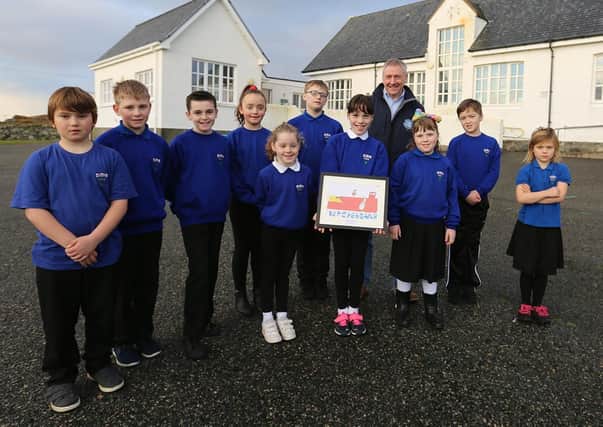 Stuart Witts, The Scottish Salmon Company’s area manager for East Loch Roag on Lewis, with Ava Douglas and her  classmates at Bernera Primary