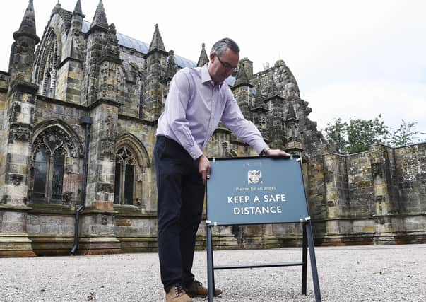 Ian Gardner, director at Rosslyn Chapel Trust, makes the finishing touches ahead of the world-famous church reopening to visitors. Photo: Lisa Ferguson