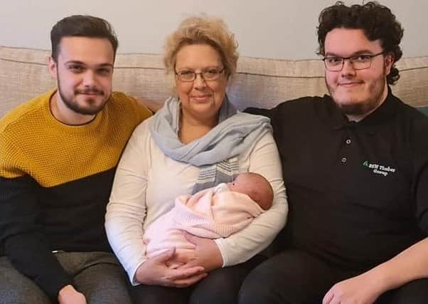 New arrival...Fiona Morris was able to celebrate the birth of her first grandchild Iona Louise last month with her sons, the proud dad Liam (left) and uncle Rian.