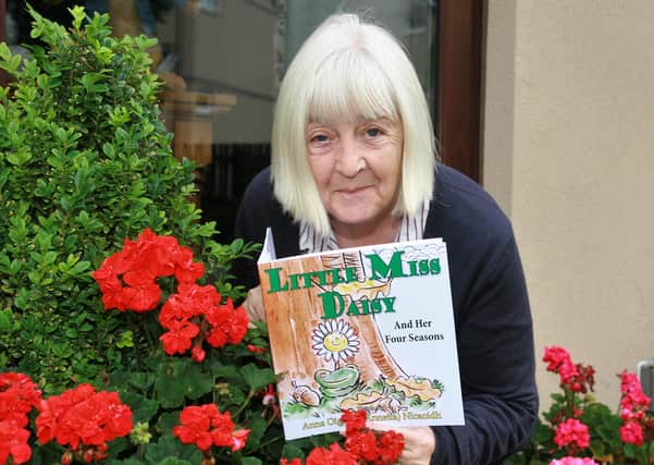 Annetta Steel with her recently published children’s book Little Miss Daisy and Her Four Seasons.