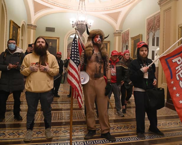Supporters of US President Donald Trump enter the US Capitol , in Washington. -(Photo by Saul LOEB / AFP) (Photo by SAUL LOEB/AFP via Getty Images)