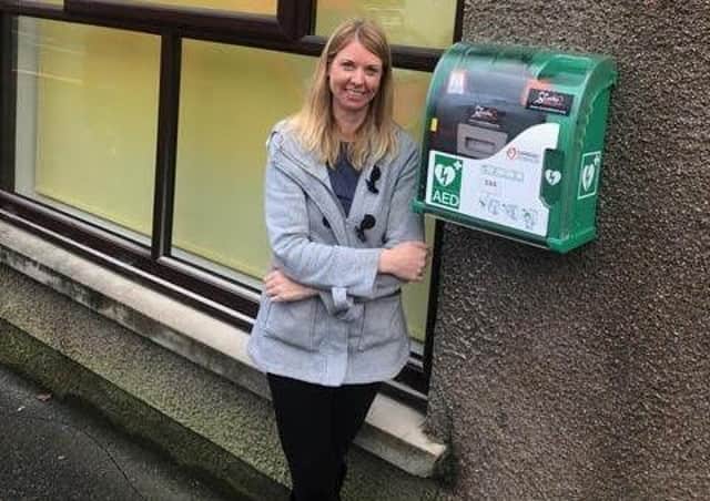 Michelle, pictured outside the offices of island MP Angus MacNeil with the newly installed defib.
