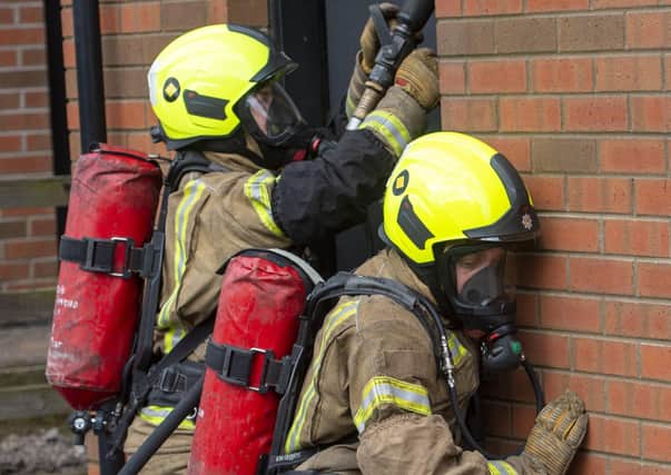 Fire officers undertaking BA training in a live exercise.