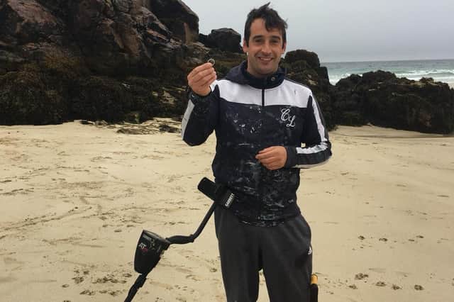 LOCAL HERO: Stephen MacLeod finds the ring on Garry beach after searching for an hour with his metal detector