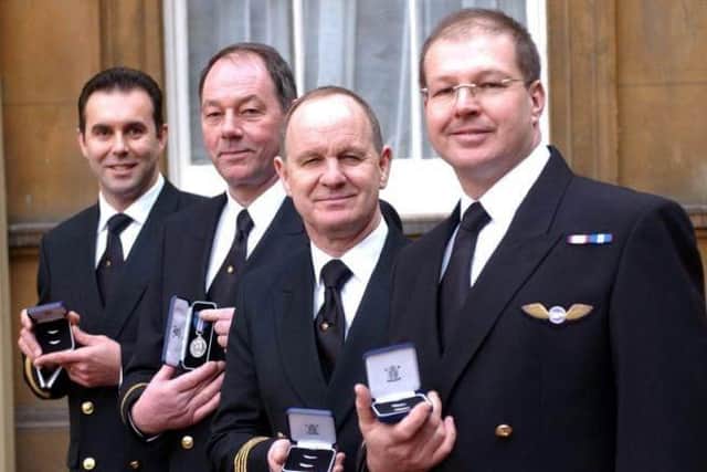 Chris (second from left) receiving the bravery medal with the other crew members