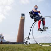 PENNY FOR YOUR THOUGHTS:  Tom Clowes finished the charity cycle on his penny farthing at the Buff of Lewis lighthouse. (Pic: John MacKinnon)
