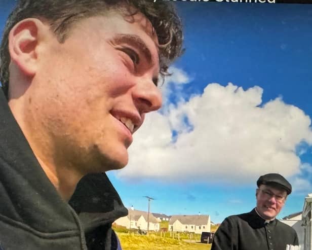 Arieh trades languages with Father Ross Crichton