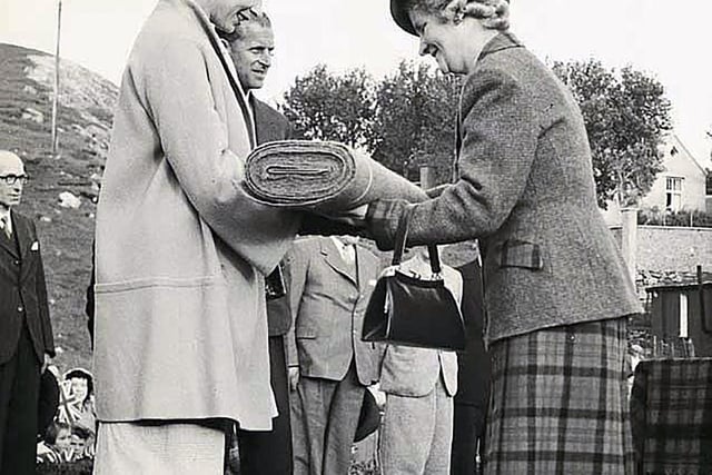 The Queen in Tarbert being presented with Harris Tweed by Mrs Joan Macdonald, wife of Alasdair Macdonald, Creagard, Drinishader. (Harris Tweed Authority)