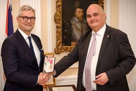 Erik Østergaard (left) receiving his Honorary OBE from British Ambassador Dominic Schroeder in February 2020