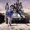 Henry Naylor poses in front of a tank with Afghan fighters. Both he and photographer Sam Maynard were lucky to escape with their lives.