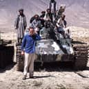Henry Naylor poses in front of a tank with Afghan fighters. Both he and photographer Sam Maynard were lucky to escape with their lives.