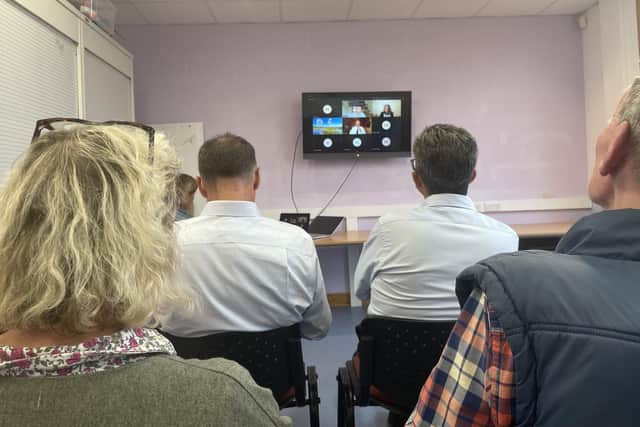 Members of the community listen in to the decision deliberations. It's clear now why board members appeared unconvinced of their position.