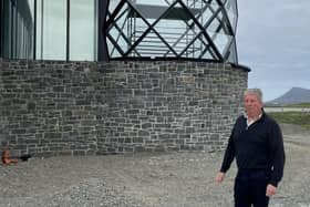 Angus A MacMillan in front of the new lighthouse-inspired feature and (inset) a bottle of Molucca Rum