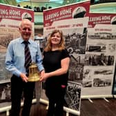 Liza Mulholland presents the bell to Ken Galloway of the Stornoway Historical Society.
