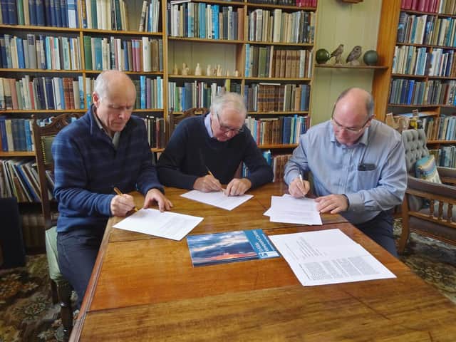 The three community chairs involved in the St Kilda Trail signing the Memorandum of Understanding