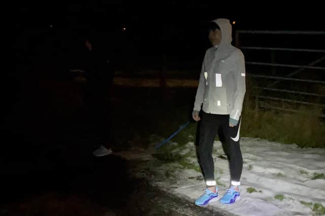This image shows one person wearing reflective panels, while another jogger is in dark clothing