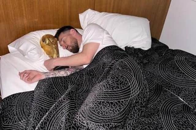 The picture that tells a footballing story: Messi asleep with the World Cup trophy.