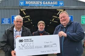 From left to right: Donald MacLeod (WICCI chair), garage owner Norrie Macrae and Iain Don Maciver