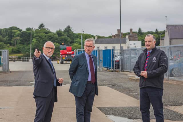THE WAY AHEAD: Comhairle Leader Roddie MacKay and Alex MacLeod, chief executive of the port authority, show Michael Gove around the harbour. Pic: Fiona Rennie