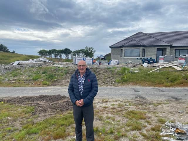 Neil James MacAulay in front of the house the estate tried to block.