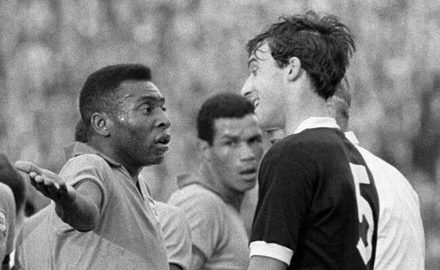 Pele gesticulates to Ronnie MacKinnon about about the treatment being handed out to him during a Scotland v Brazil friendly in 1966.
