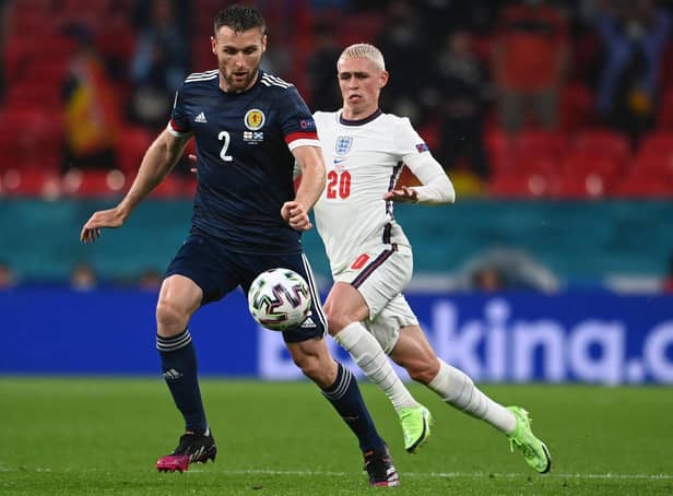 Scotland ace Stephen O'Donnell is pictured with England star Phil Foden during Friday's clash (Pic by Getty Images)