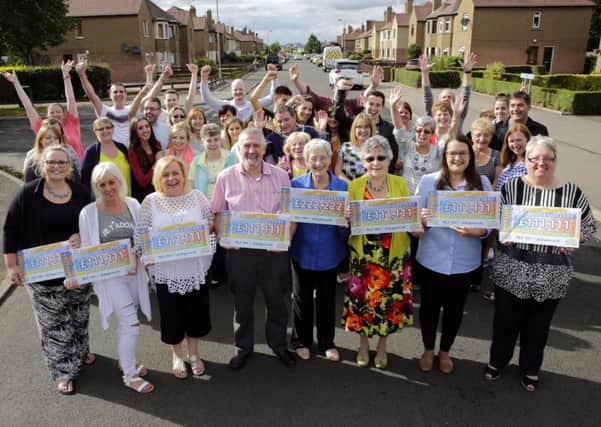 The lucky People's Postcode Lottery winners in Grangemouth celebrate with family and friends