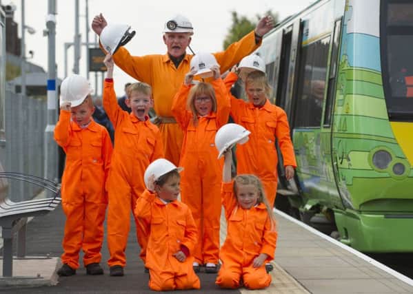 Kids from St Andrews Primary school in Gorebridge greet the train as it arrives in to Newtongrange station. Picture: Lesley Martin