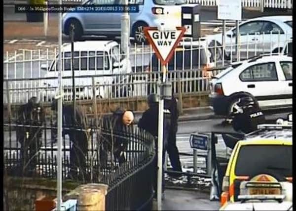 Snapshot of CCTV which shows two men being arrested for a terrifying raid.