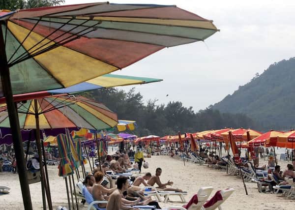 Tourists relax at Patong beach in Phuket province. Picture: AP