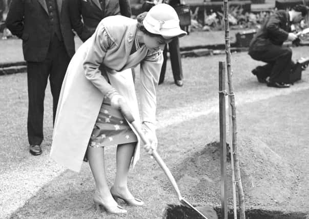 Queen Elizabeth II plants a tree at the Canongate Church during her first visit to Edinburgh as Queen in 1952.