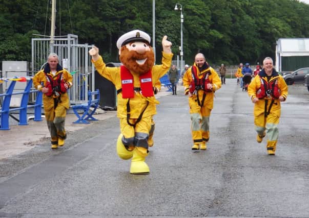 Mascot Stormy Sam leads out the Lifeboat guys