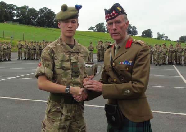 Cpl Christopher Palmer receiving Most Improved Student Trophy for JCIC from Commandant Colonel Iain Cassidy.