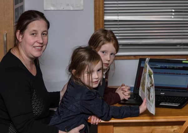 Pictured are Megan Macdonald and her children at homework time.