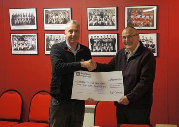 Pictured is Point and Sandwick Trusts Calum MacDonald handing over the cheque to Cairdean chairman Bert Frater.