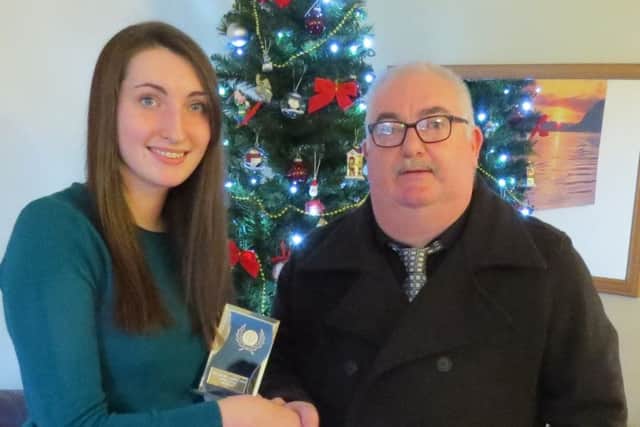 Amy Mackay being presented with the Runner-up award by Calum Iain Macleod, Trustee, Donald Stewart Memorial Trust