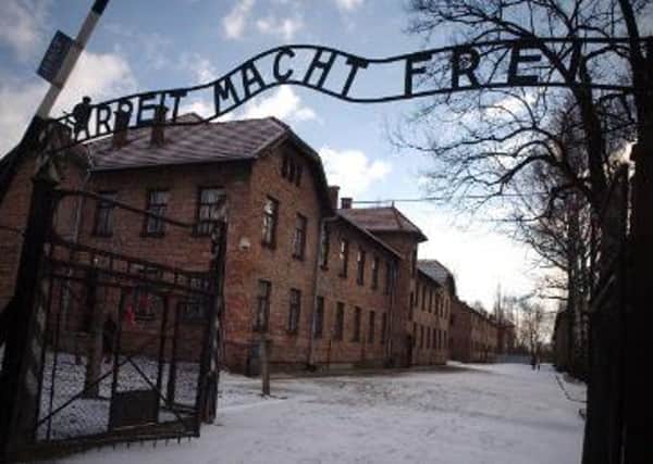 The Nazis established camps where they imprisoned the victims of their hatred. Pictured are the gates of Auschwitz today photo by Bill Hunt.