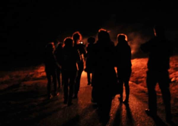 Walkers Following the Torchlit Procession at Gallan Head, photo by Robert Shaw.