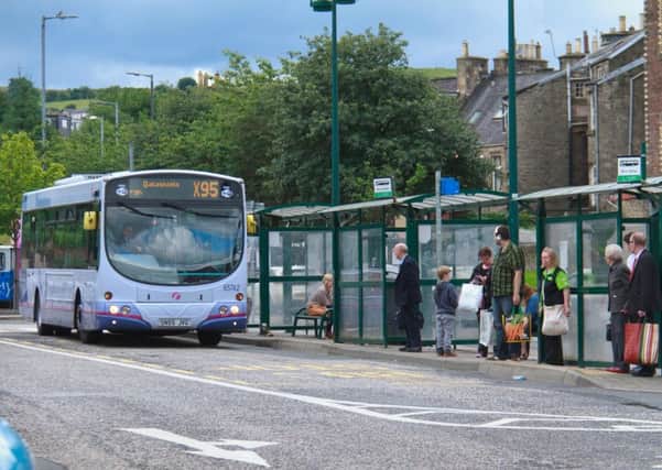 Passengers waiting for an X95 bus in Hawick.