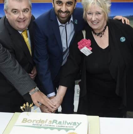 Transport minister Humza Yousaf, centre, and MSP Christine Grahame, with Scottish Borders Council leader David Parker, at an event last year to celebrate the success of the Borders Railway after its first year in operation. That success is now being blamed for a fall in the number of passengers using First's X95 service, however.