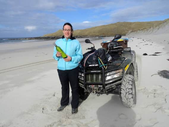 Eilidh Carr with the bottle she found on the beaches in Sollas, North Uist.