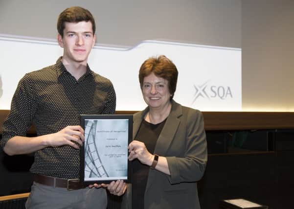 SQA Chief Executive Janet Brown presents Iain MacPhee from Sgoil Lionacleit on Benbecula with a commemorative certificate at the screening of his short film at the Glasgow Film Theatre.