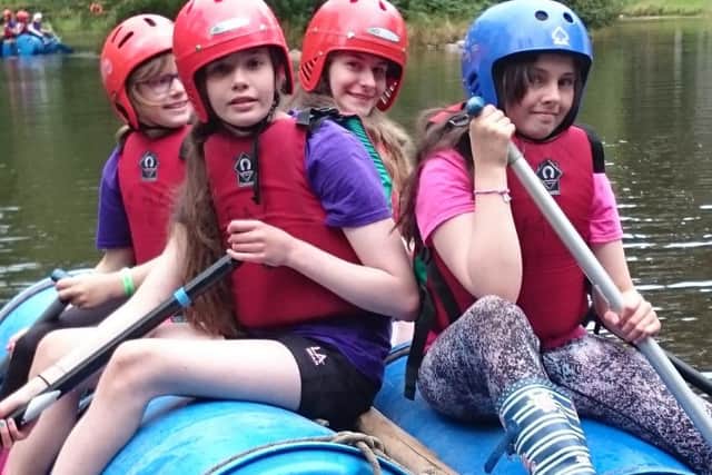 Pictured are Lewis Guides enjoying rafting at Girlguiding Regional Camp.
