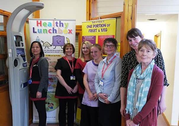 Pictured with the health monitor are: Group Practice staff - Upin Macrae, Jeanette Buchanan, Dawn Morrow, Mairi Crate, Annette Stevenson, Jennifer Ellis and Erika Anderson.