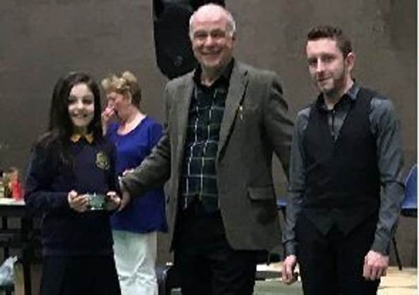 Sgoil Eolaigearraidh conductor John James Galbraith and pupil with Anne and Len Maguire Trophy.