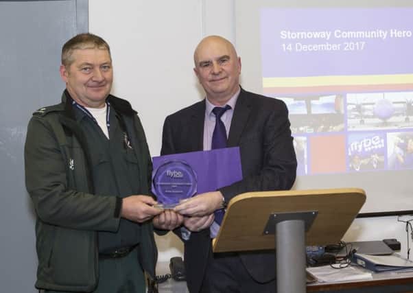Roddy Macdonald receives his Community Hero award from David Paterson.