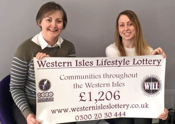 Anna Stewart of Uig Committee Centre Committee being presented with a cheque by Emma Fraser of WILL.