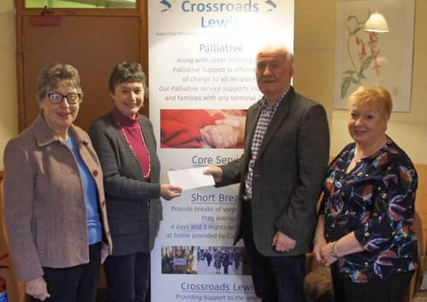 Point and Sandwick board member Liz Chaplain hands the cheque over to Crossroads Lewis chair Malcolm Smith, joined by Crossroads Lewis board member Donna Macleod (left) and Crossroads Lewis manager Rhoda Macdonald.